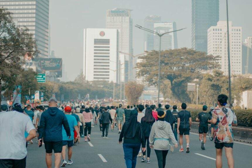 Adults running outdoors, the kind of movement wearable metrics record as steps and distance