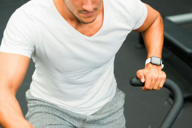 Adult cycling on a gym stationary bike, the kind of aerobic training linked to better endothelial function