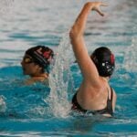 Two artistic swimmers training in a pool, the setting of a two-season injury surveillance study