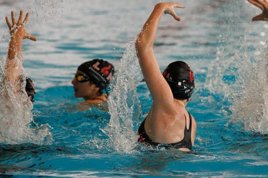 Two artistic swimmers training in a pool, the setting of a two-season injury surveillance study