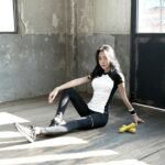 An athlete sitting on the floor stretching the hamstrings, the comparison condition in the myofascial release trial