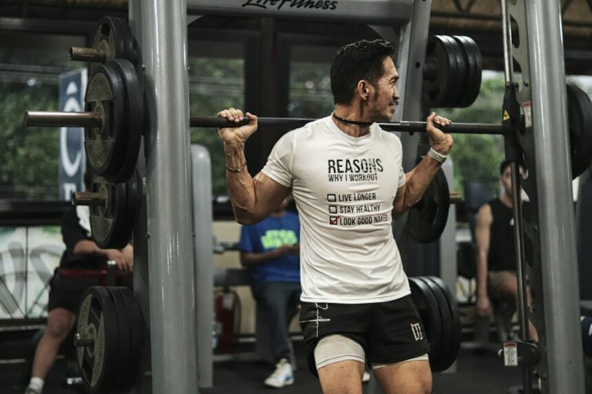 Athlete performing a barbell back squat during velocity-based training in a gym
