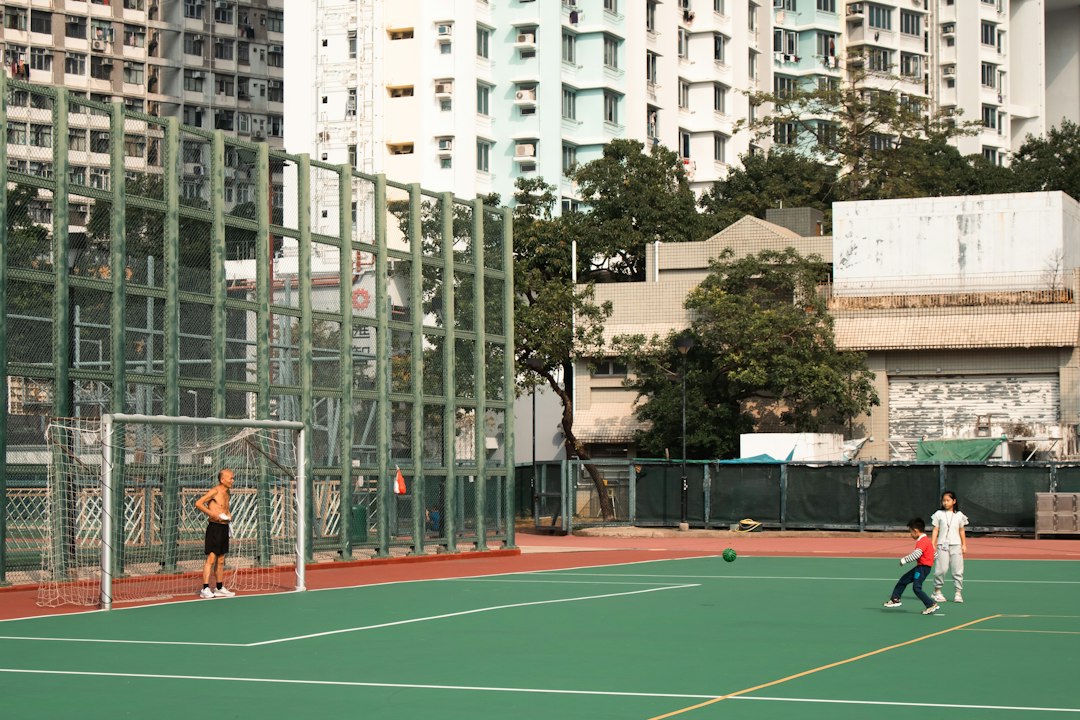 Children playing football on an outdoor court in a report on working memory and exercise type