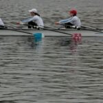 A crew of rowers pulling hard as neuromuscular fatigue builds late in a row