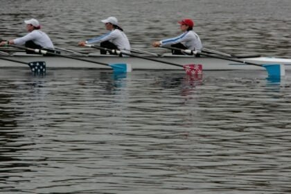 A crew of rowers pulling hard as neuromuscular fatigue builds late in a row
