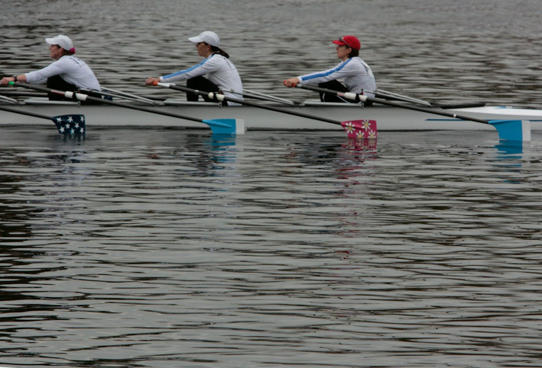 A crew of rowers pulling hard as neuromuscular fatigue builds late in a row