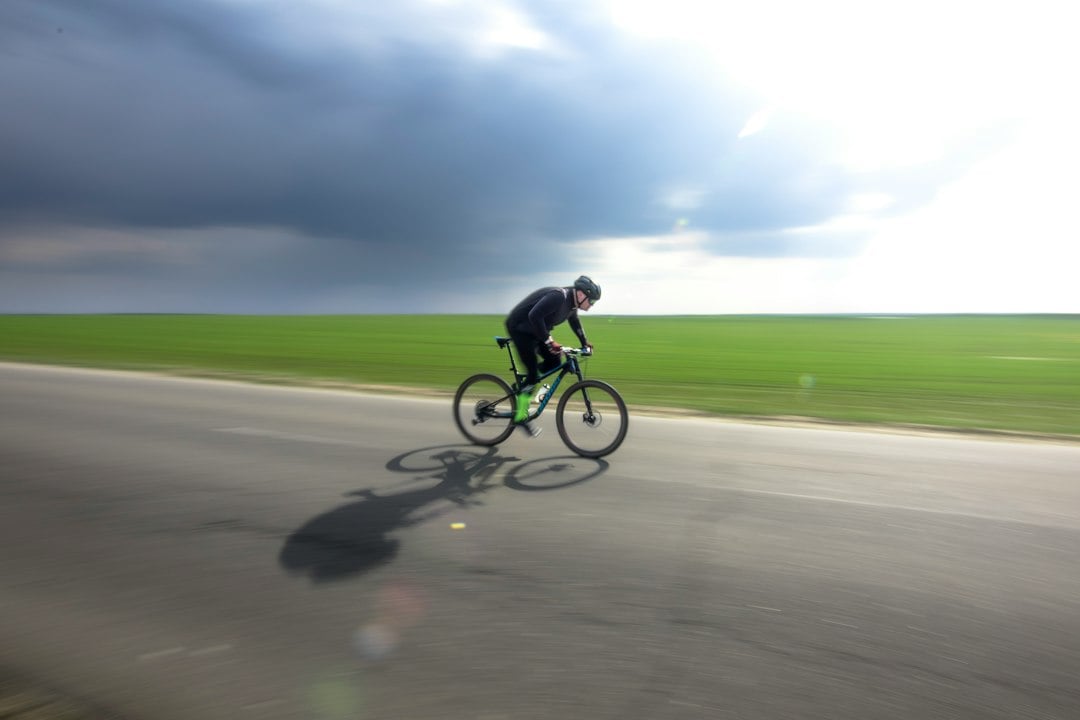 A cyclist riding an open road, the endurance setting where dietary nitrate is most often tested