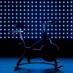 Stationary exercise bike against a blue background