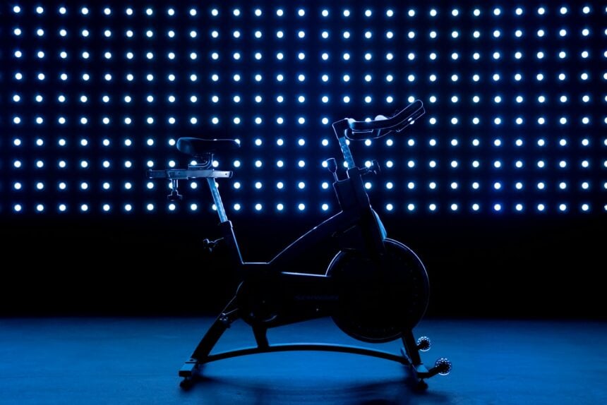 Stationary exercise bike against a blue background