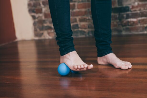 Bare foot rolling a massage ball on the floor, illustrating flexible flatfoot exercise research