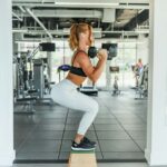 Gym member holding a squat position, the kind of isometric exercise used in blood pressure training trials