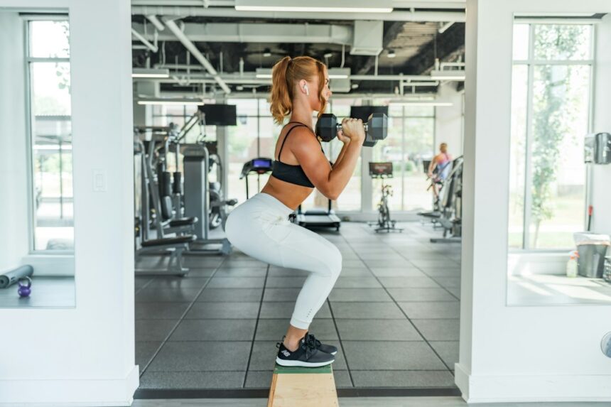 Gym member holding a squat position, the kind of isometric exercise used in blood pressure training trials