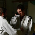 Judo athletes training on the mat, the combat sports setting where reaction time was measured