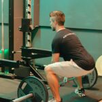 A lifter squatting in a gym, the squat training that elite powerlifters build their totals on