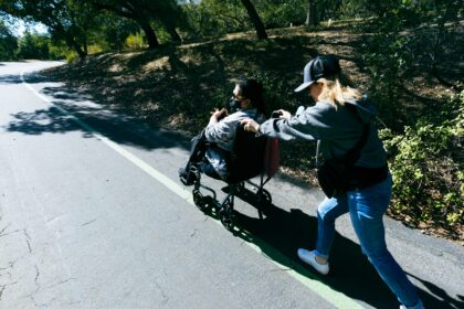Mother and child walking a park path, illustrating postpartum exercise habits followed for four years