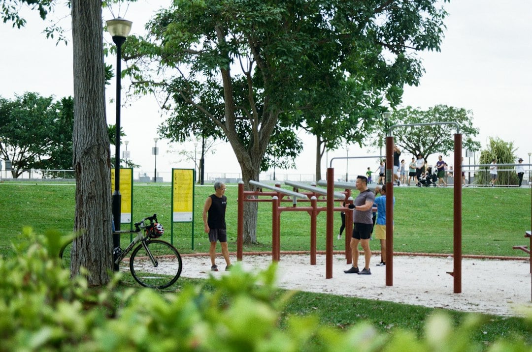 People exercising outdoors, reflecting the weekly activity totals counted in the Parkinson disease cohort