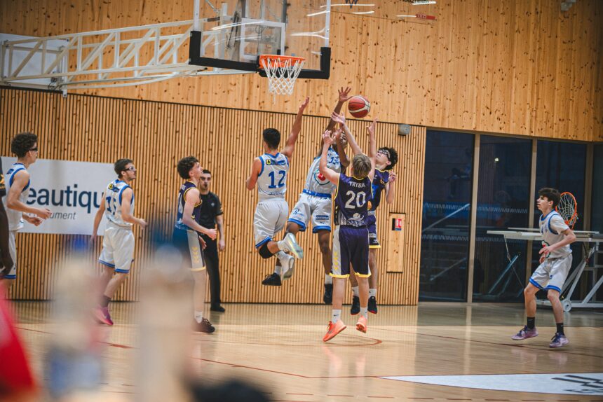 Players contesting a rebound in a match, the kind of load that countermovement jump testing is used to monitor