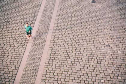 A recreational runner mid-stride on a city path, the population studied in gait retraining research