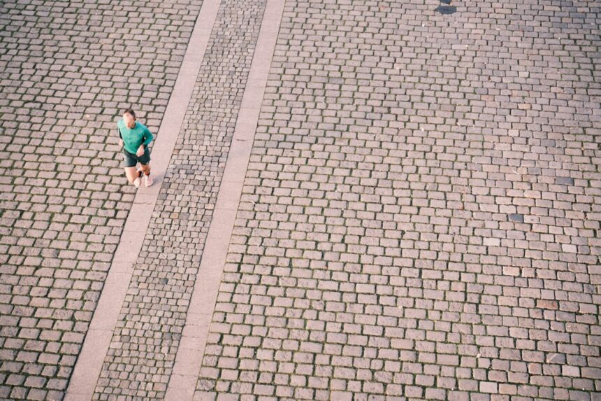 A recreational runner mid-stride on a city path, the population studied in gait retraining research