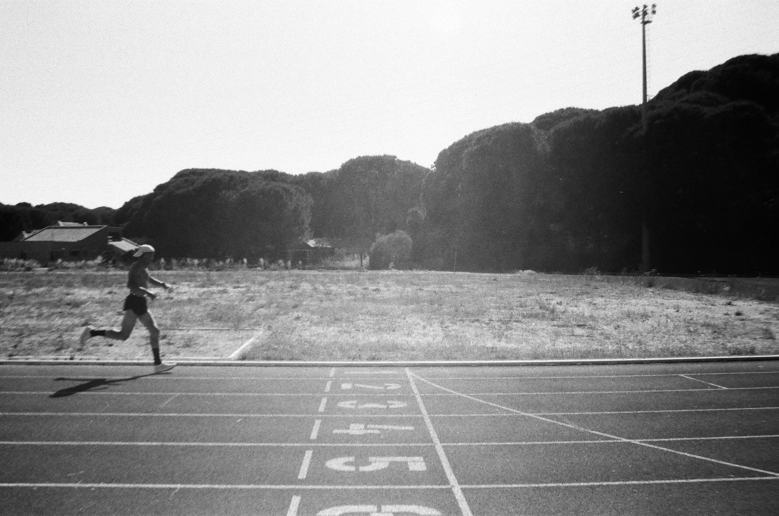 A runner in a numbered lane, the setting for the running performance tests in the study