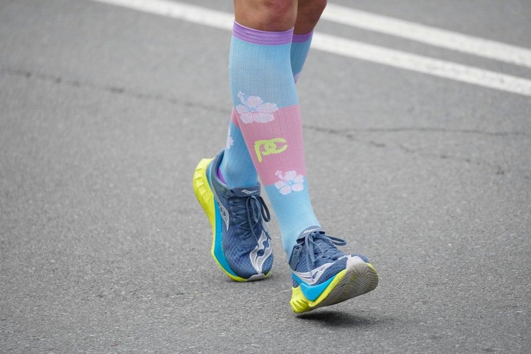 Runner legs in long socks resembling the compression garments tested in team sport research