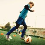 Child dribbling a soccer ball, the kind of coordination drill tested for working memory gains