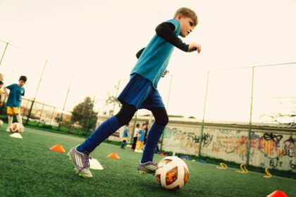 Child dribbling a soccer ball, the kind of coordination drill tested for working memory gains