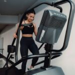 Woman running on a gym treadmill, the supervised exercise arm tested alongside time-restricted eating