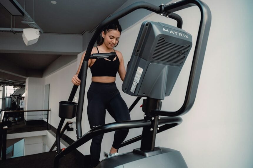 Woman running on a gym treadmill, the supervised exercise arm tested alongside time-restricted eating