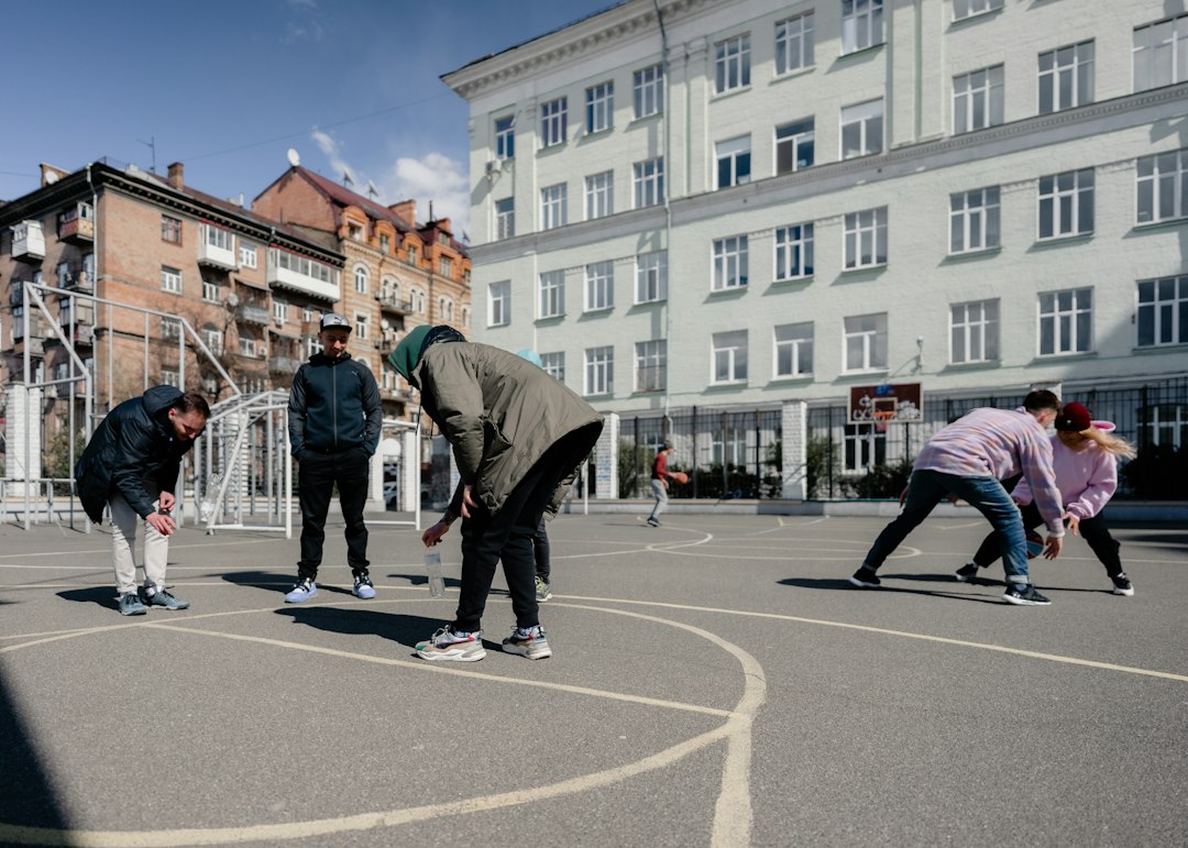 Teenagers playing basketball outdoors, the kind of daily movement behind the cardiovascular health activity score