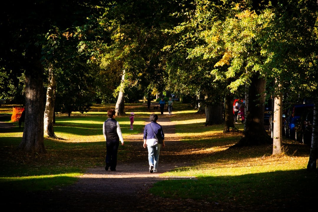 Two people walking outdoors, the activity pattern tied to lower pancreatitis risk