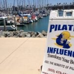 Pilates Influence sign at the Channel Islands Harbor boardwalk in Oxnard California