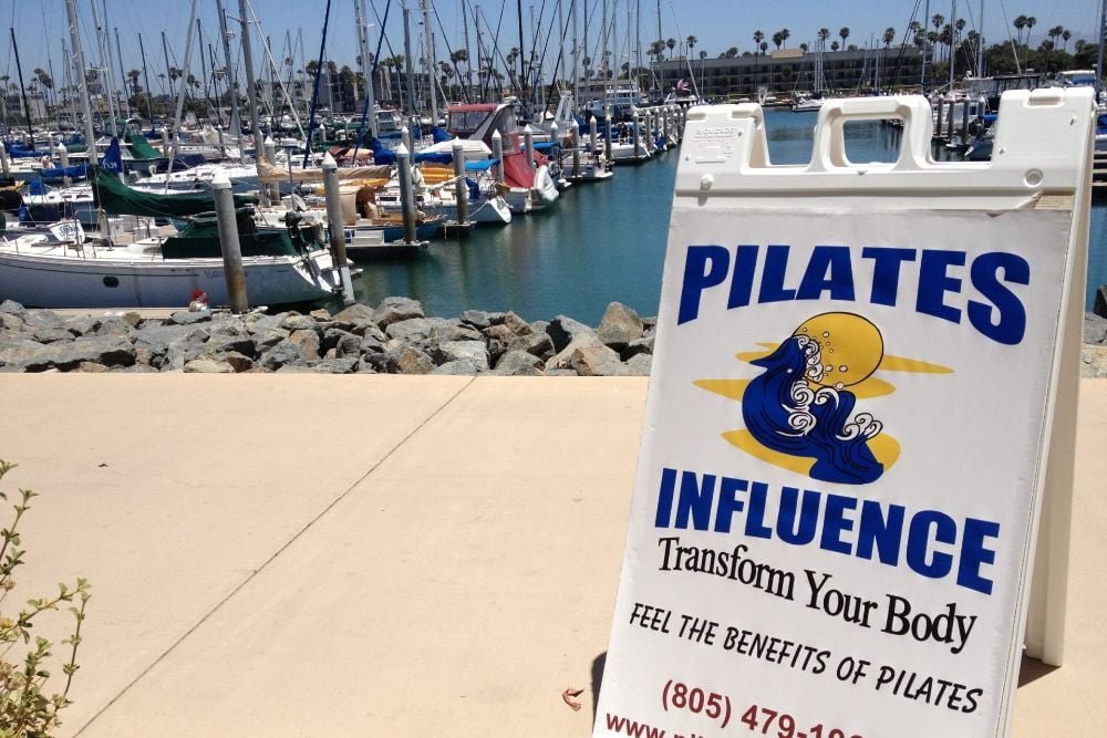 Pilates Influence sign at the Channel Islands Harbor boardwalk in Oxnard California